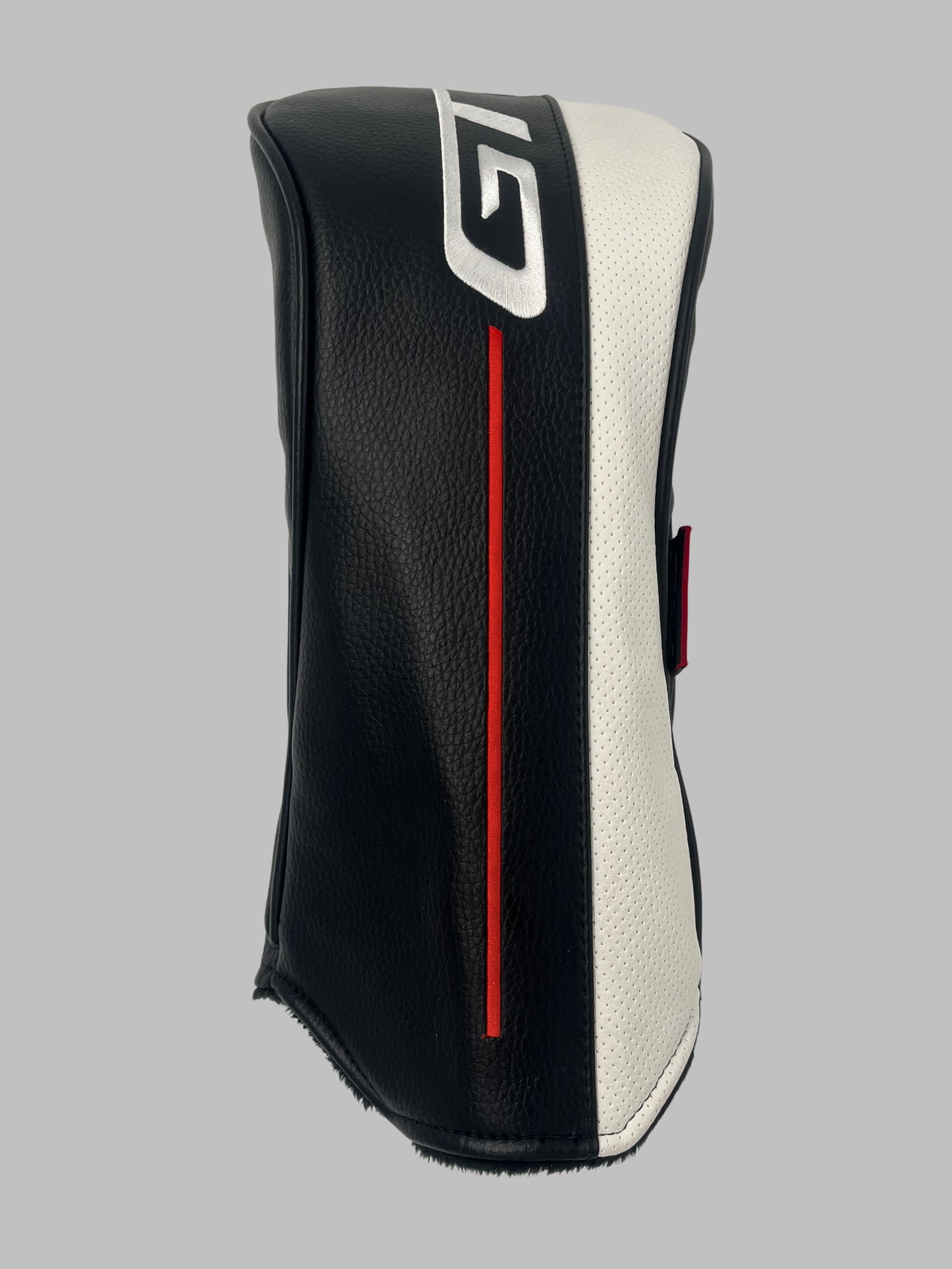 Golfklubbens headcover i svart och vit med röd accent